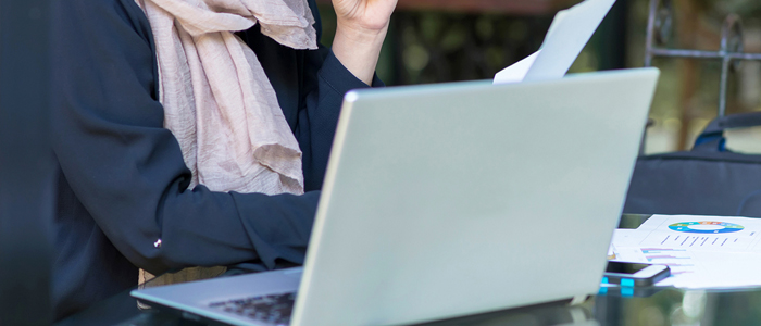 Photo of person sitting at laptop diversity