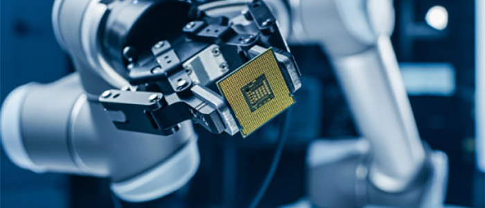 A photo of a robot arm holding a processing chip