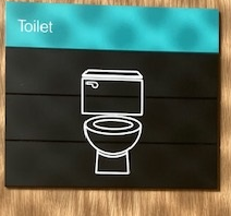 Signage on toilet in the Clarice Pears building, with a graphic plus the text 