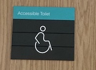 Signage on accessible toilet in the Clarice Pears building, with a graphic plus the text 